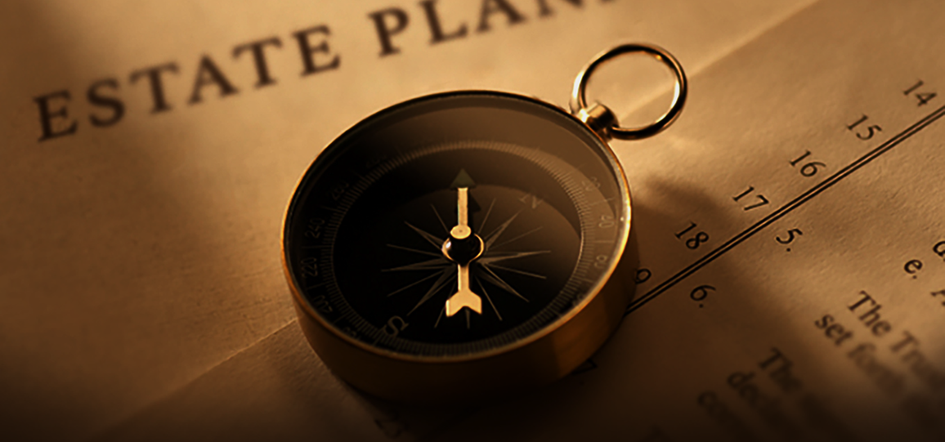 Photo of estate planning documents with a compass on top of papers.